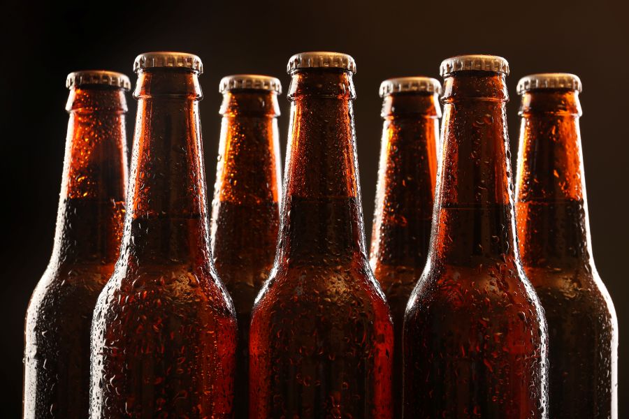 a row of unmarked beer bottles